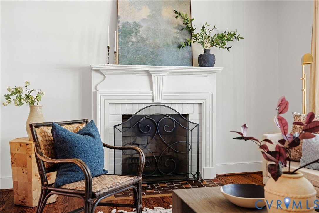 Classic fireplace with a decorative mantel, tile surround, and wrought iron screen