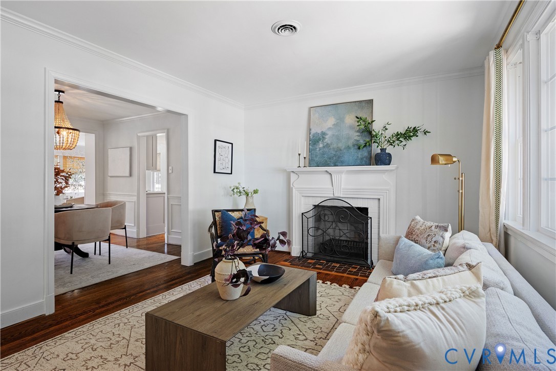 White mantel fireplace with an ornate fire screen