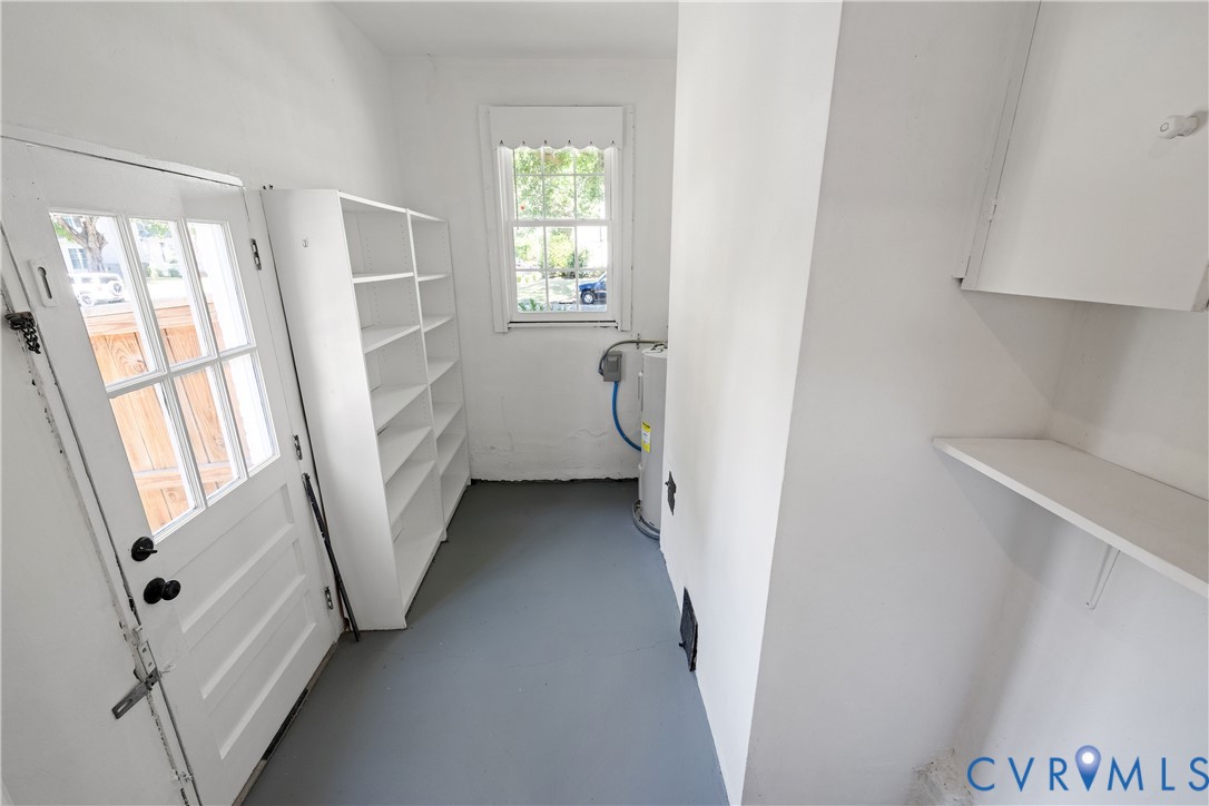 Built-in shelving, paneled door with glass inserts, and a window providing natural light
