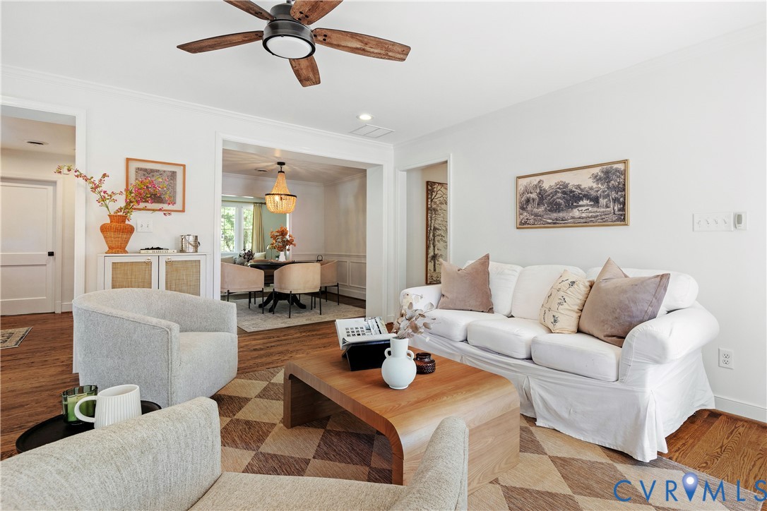 Hardwood flooring throughout, recessed lighting, and a ceiling fan with wood-finish blades