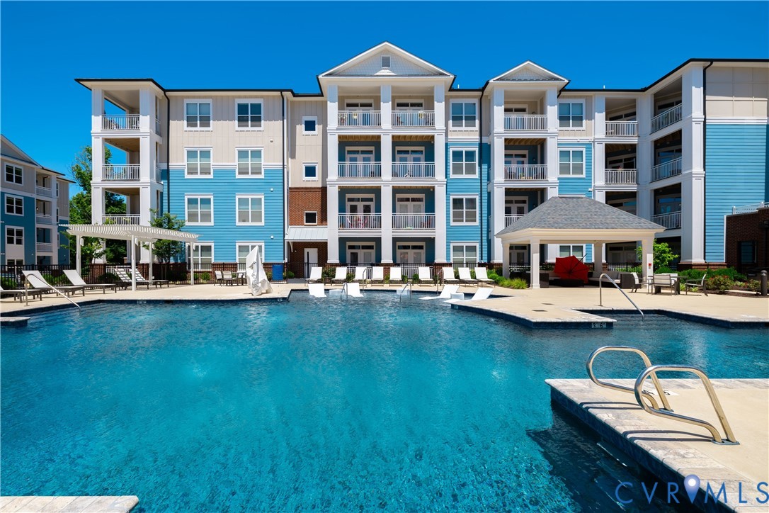 Expansive swimming pool with integrated tanning ledges, multiple entry points, and surrounding hardscape decking Expansive swimming pool with integrated tanning ledges, multiple entry points, and surrounding hardscape decking