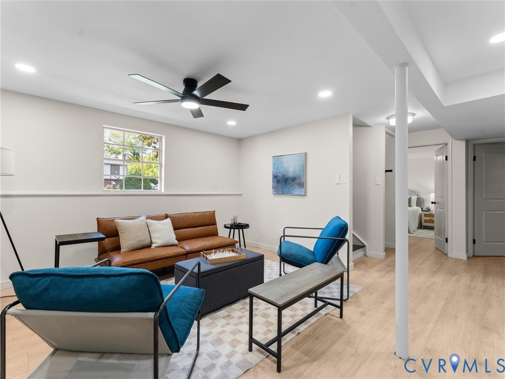 Recessed lighting, light wood-finish flooring, and a ceiling fan with integrated lighting