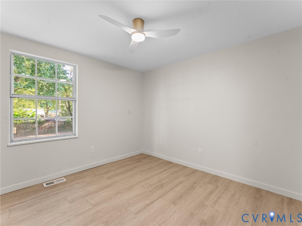 Recessed lighting, wood-finish flooring, and a modern ceiling fan with integrated lighting