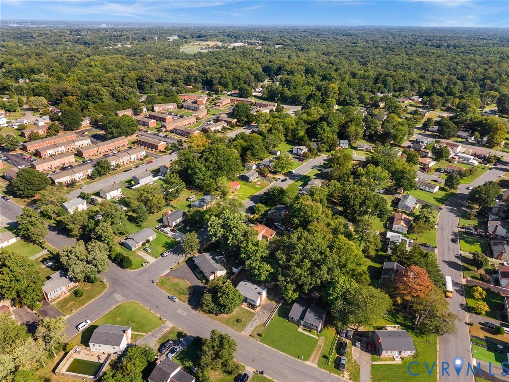 Lush, tree-lined neighborhood with a variety of residential properties and surrounding green spaces