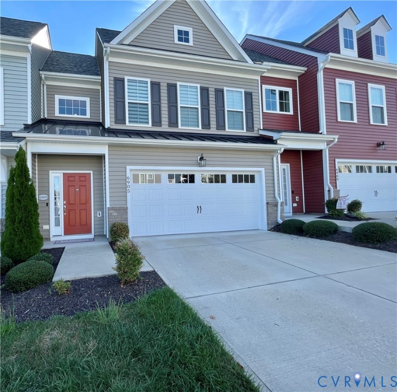 Contemporary multi-level exterior with varied siding, front-facing attached garage, and prominent gabled roofline