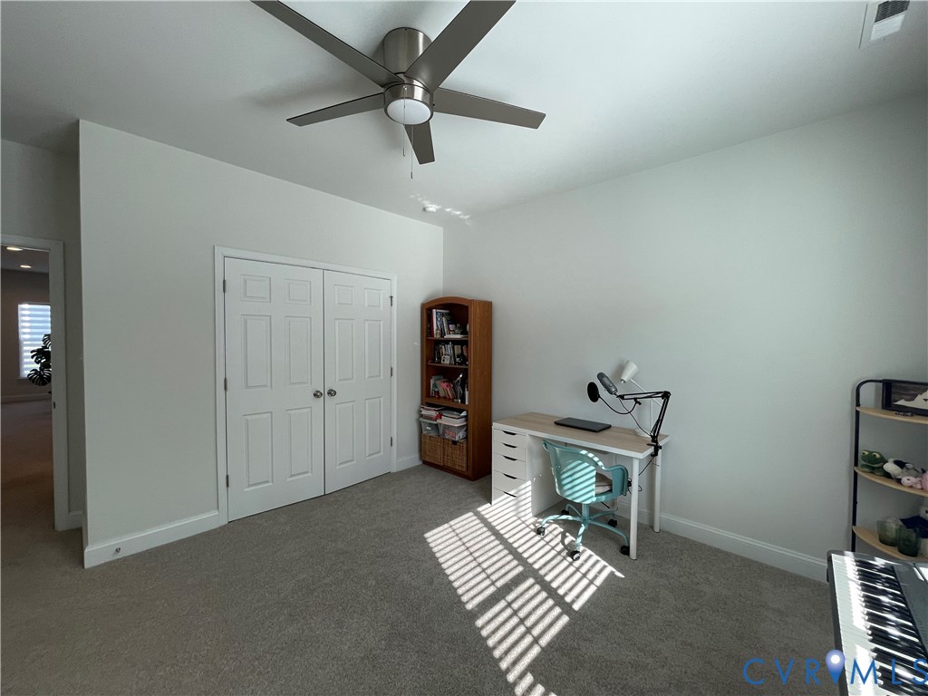 Recessed lighting, ceiling fan, neutral carpeting, and a double-door closet