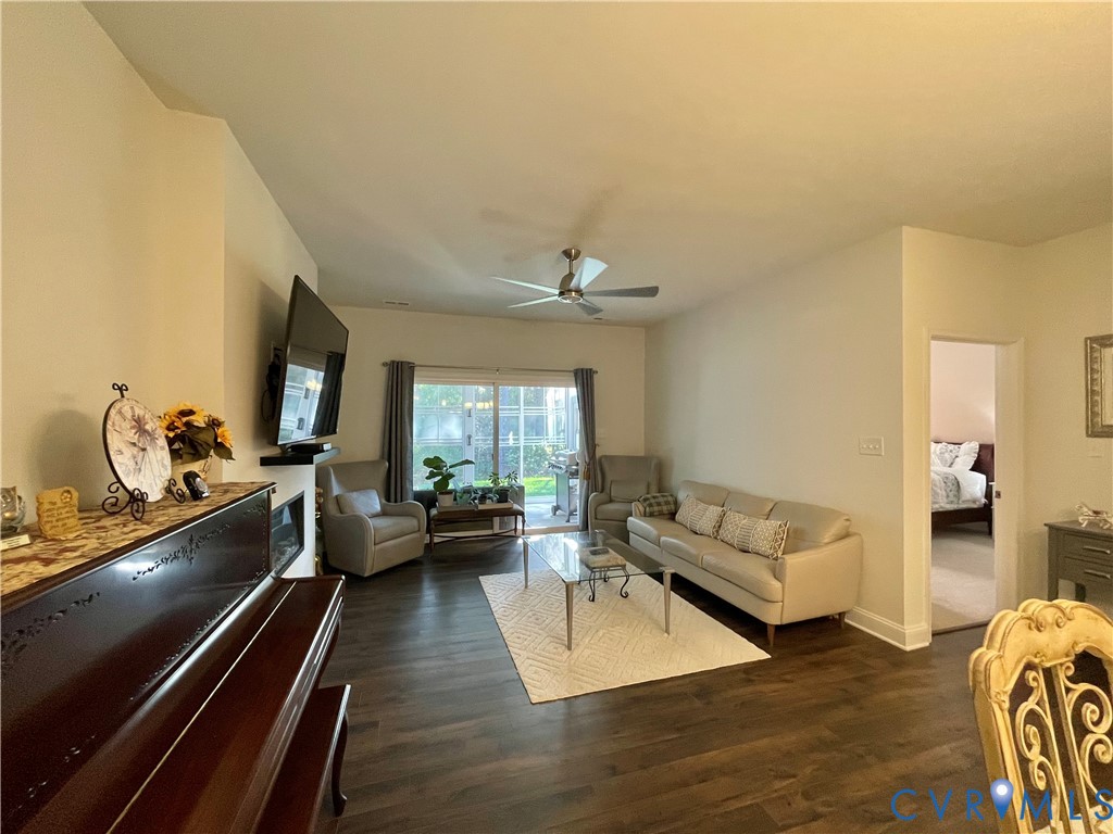 Wood-finish flooring throughout, vaulted ceiling, and recessed electric fireplace