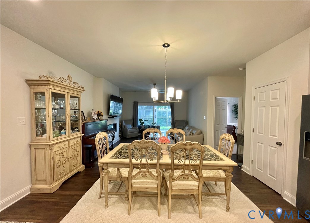 Recessed lighting, wood-finish flooring, white panel door, and pendant lighting