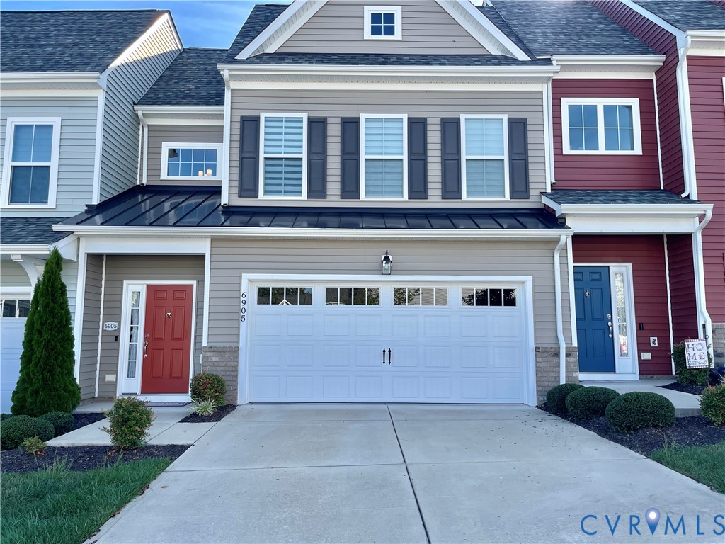 Siding exterior with decorative shutters, a single-car garage, concrete driveway, and front landscaping