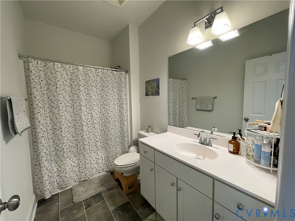 Full vanity with an integrated sink, polished chrome faucet, and ample storage