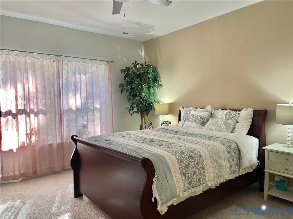 Wall-to-wall carpeting with neutral wall tones and crown molding