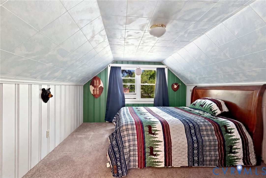 Bedroom 4 Upstairs, Built-in Dresser behind bed, Sloped ceiling with acoustic tiles, plush carpet flooring, beadboard wall paneling,