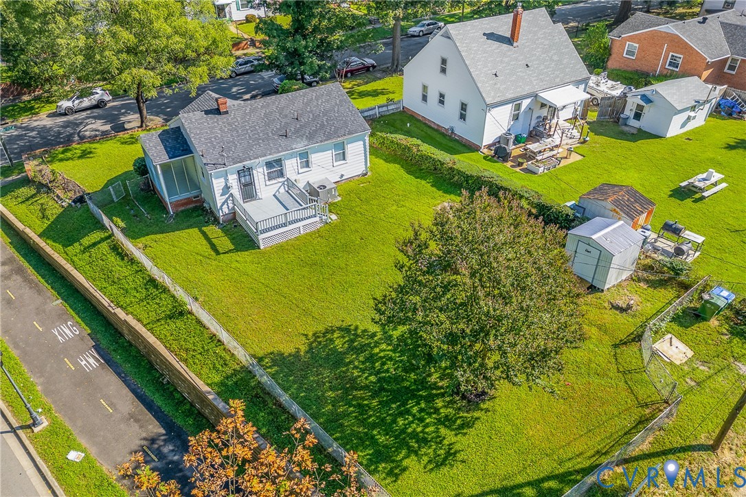 Property featuring expansive green lawns, mature trees, and a private deck