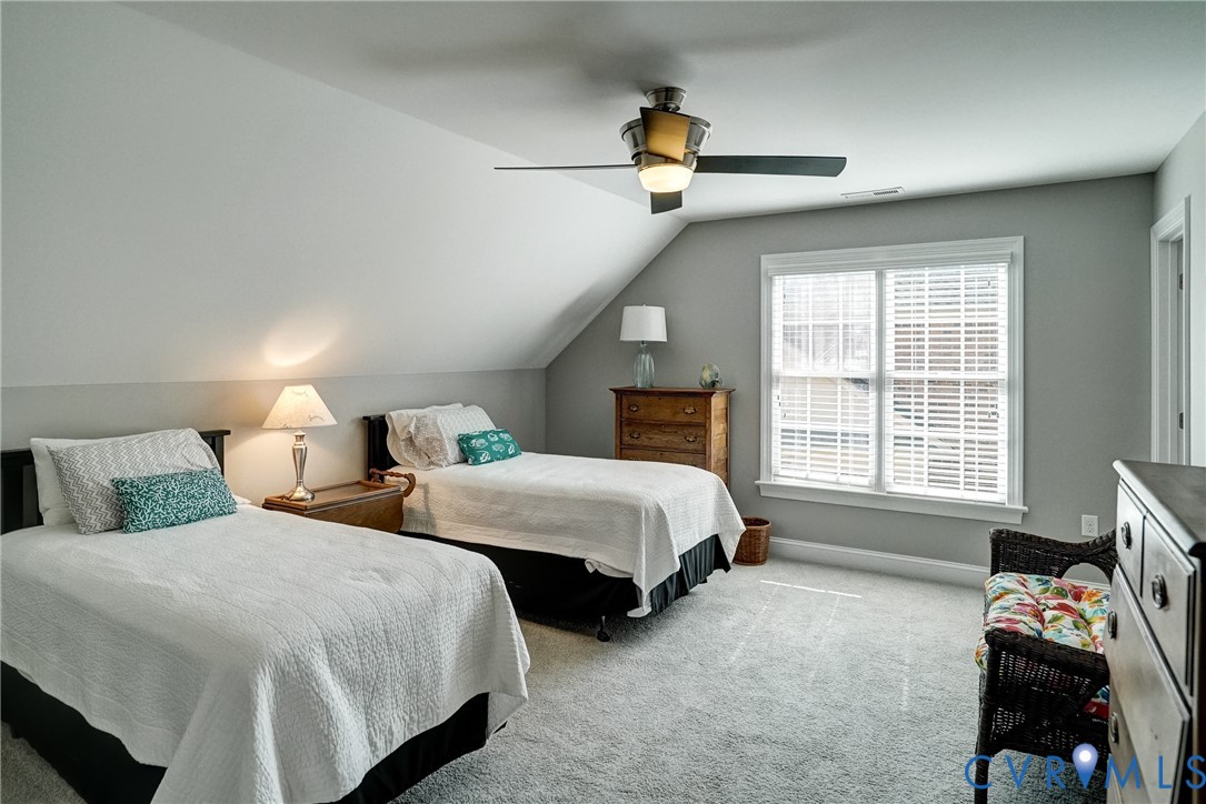 Sloping ceilings, recessed window with blinds, ceiling fan, and grey wall finish