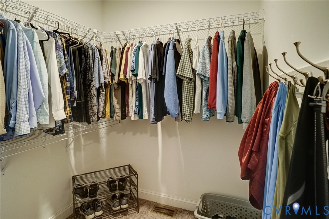 White wire shelving system with hanging rods and corner configuration