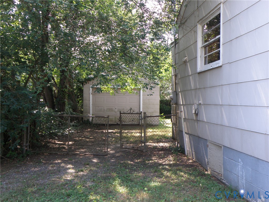 Left-side of house looking toward garage Left-side of house looking toward garage