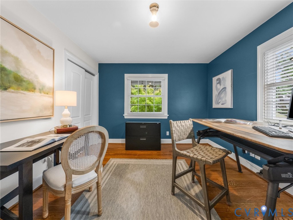Hardwood flooring, painted walls, white trim, recessed lighting, and a window with blinds