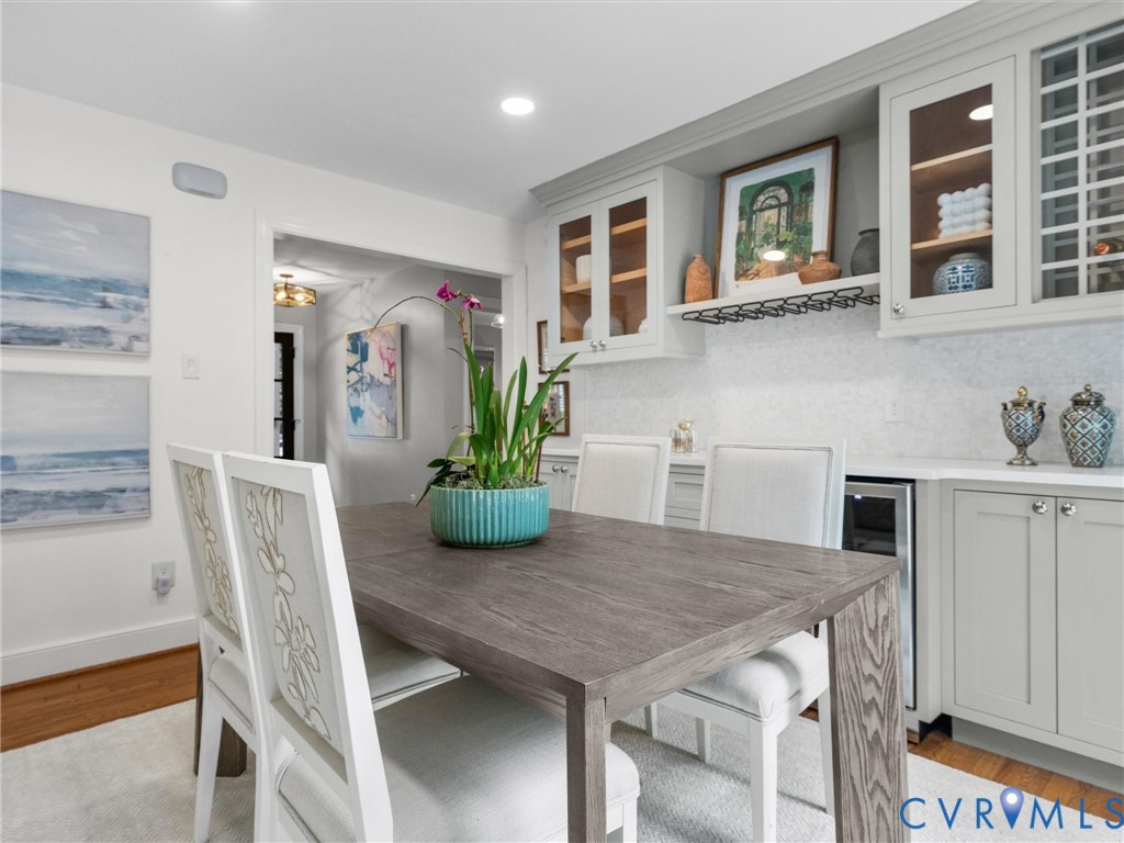 Built-in cabinetry with glass-front uppers, a wine rack, and a beverage cooler