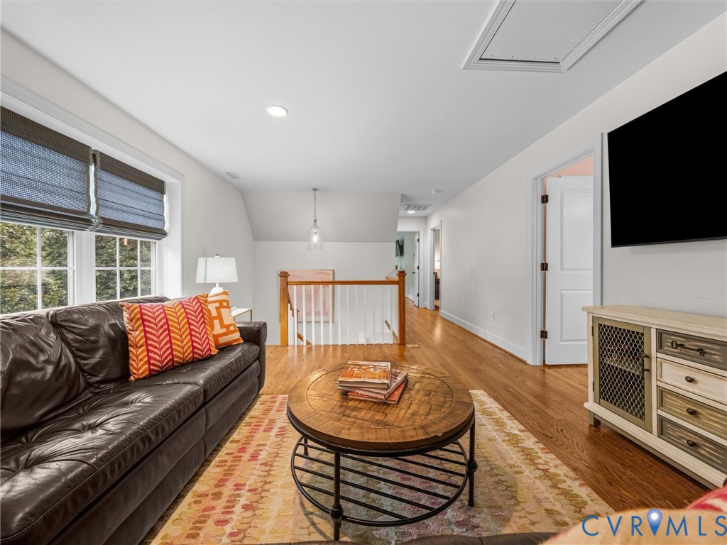 Hardwood flooring throughout, recessed lighting, and white trim