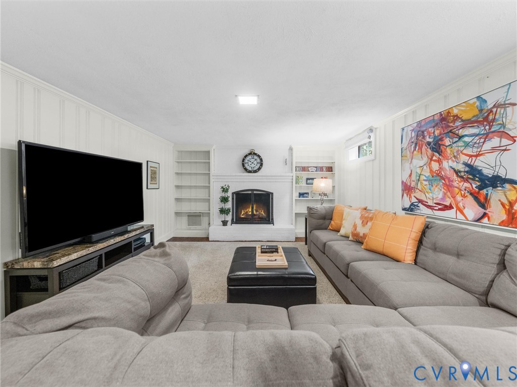 Built-in fireplace with a white surround, integrated shelving, and wall paneling