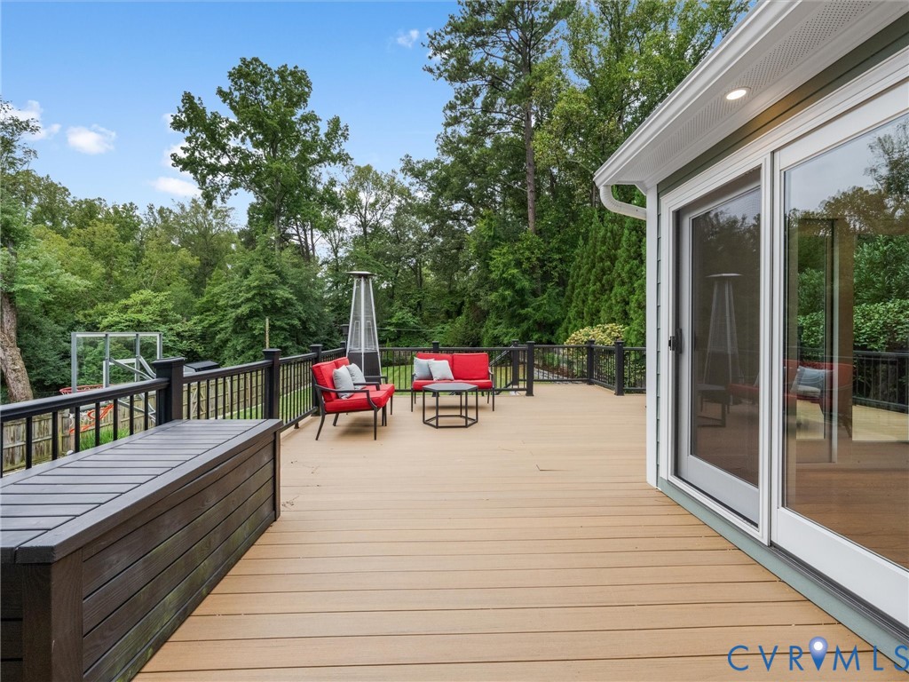 Expansive deck featuring wood-finish composite decking and black metal railings