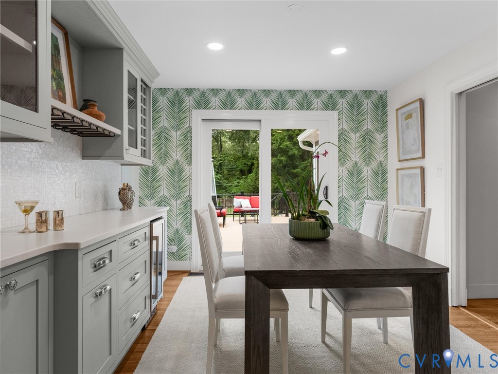 Built-in cabinetry with glass-front uppers, wine rack, and beverage refrigerator