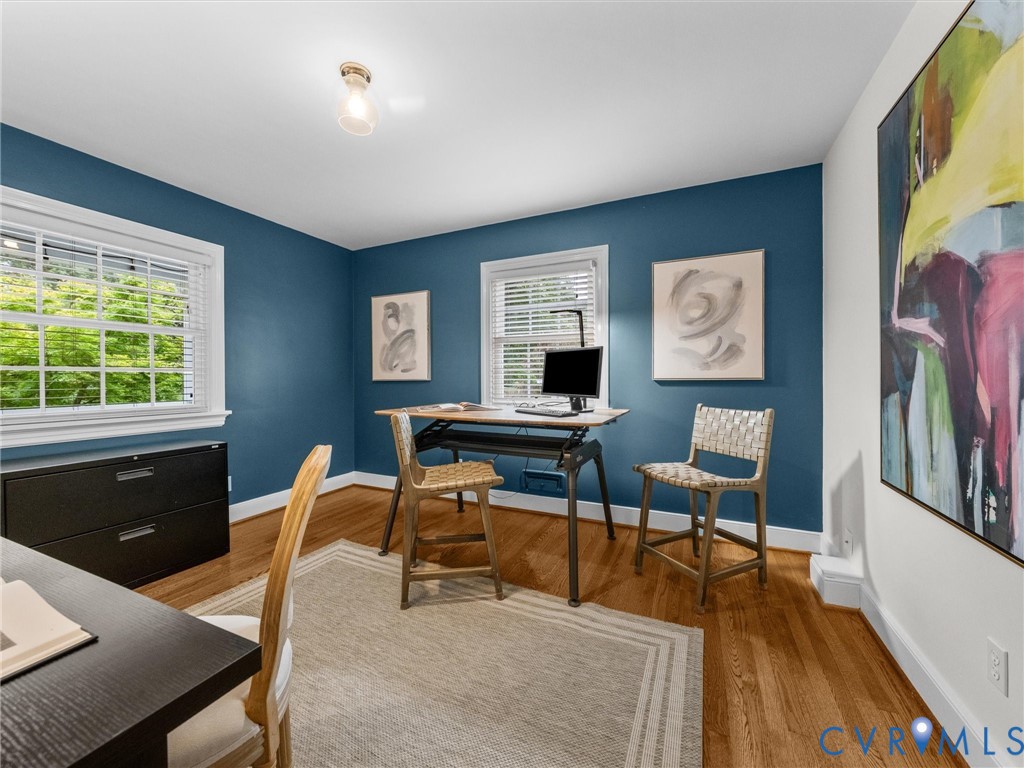 Hardwood flooring, painted walls, white trim, recessed lighting, and multiple windows