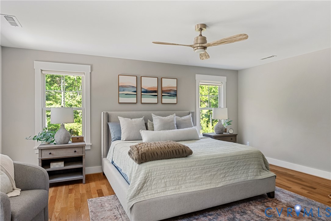 Recessed lighting, wood-finish flooring, ceiling fan, and white trim accents