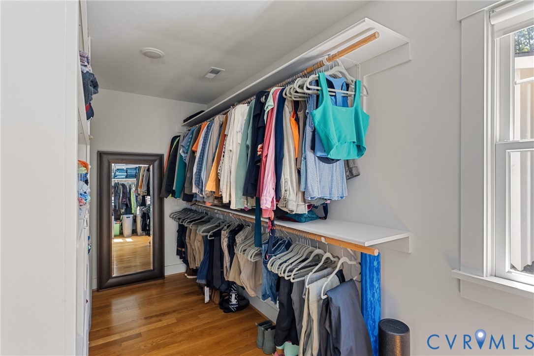 Custom closet organization system with shelving and hanging rods