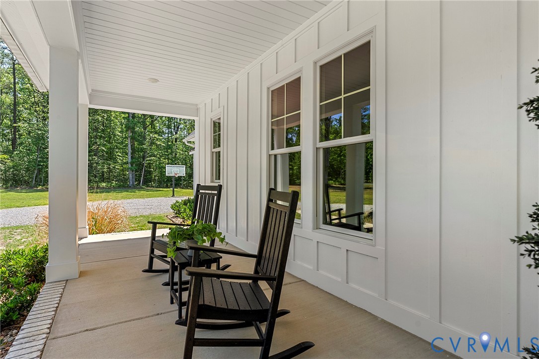 Covered porch with concrete flooring and brick edging