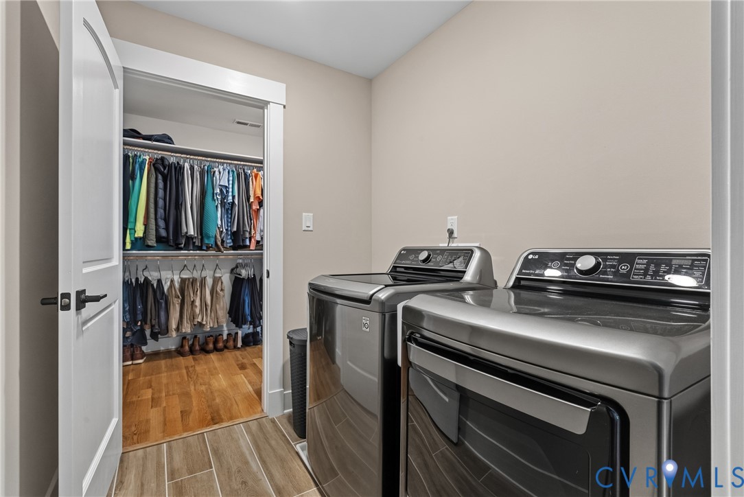 Laundry area with tile flooring and full-size appliances