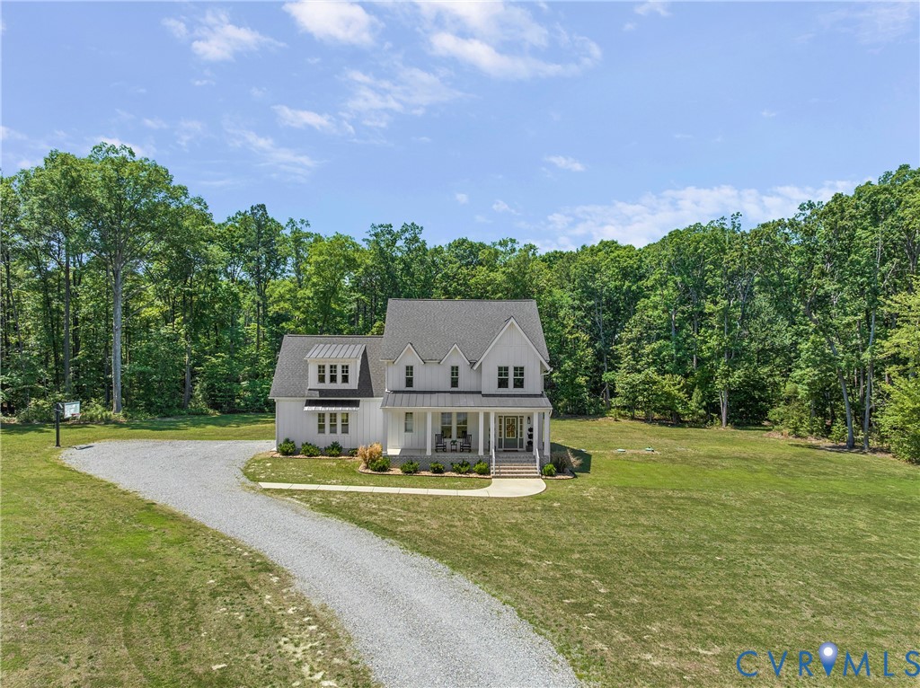 Modern farmhouse-style residence with white board-and-batten siding and a dark shingled roof