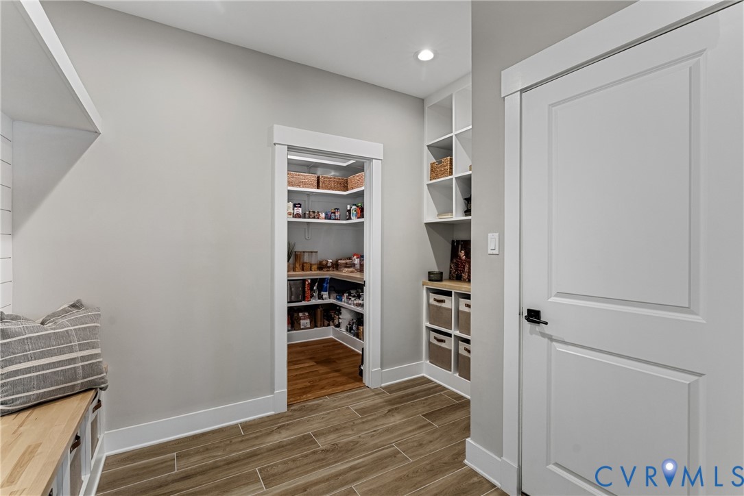 Walk-in pantry with wood-finish flooring