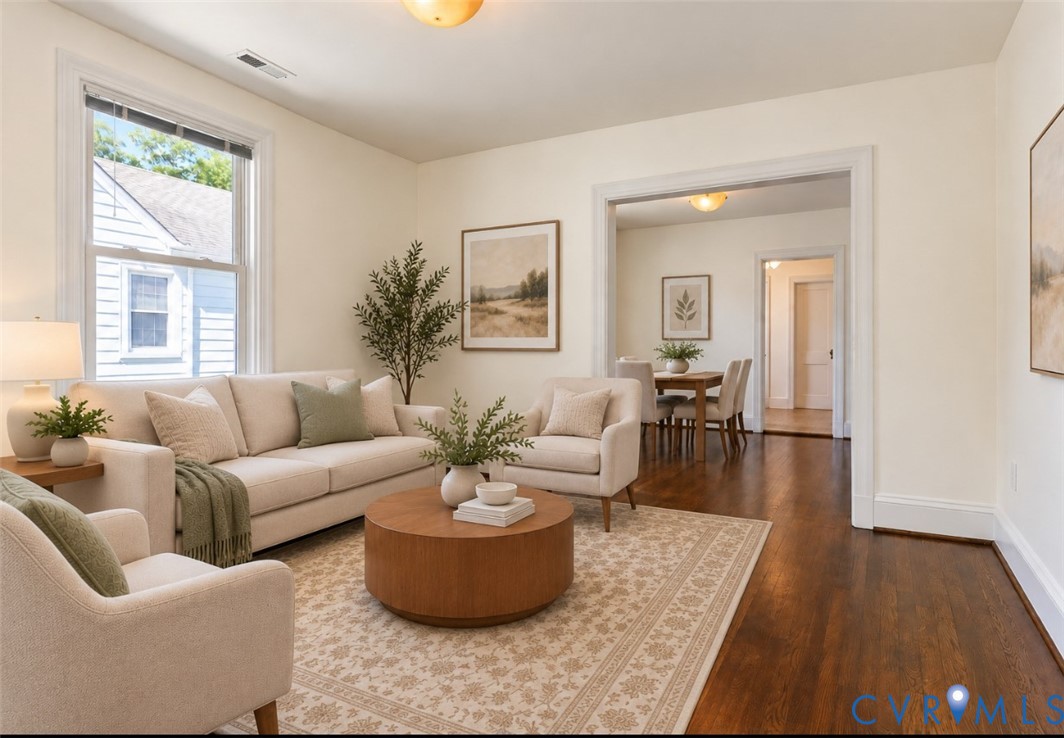 Hardwood flooring, freshly painted walls, cased openings, and ceiling light fixture