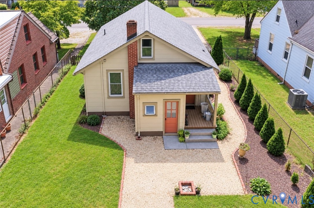 Pea gravel area with fire pit and mature perennials