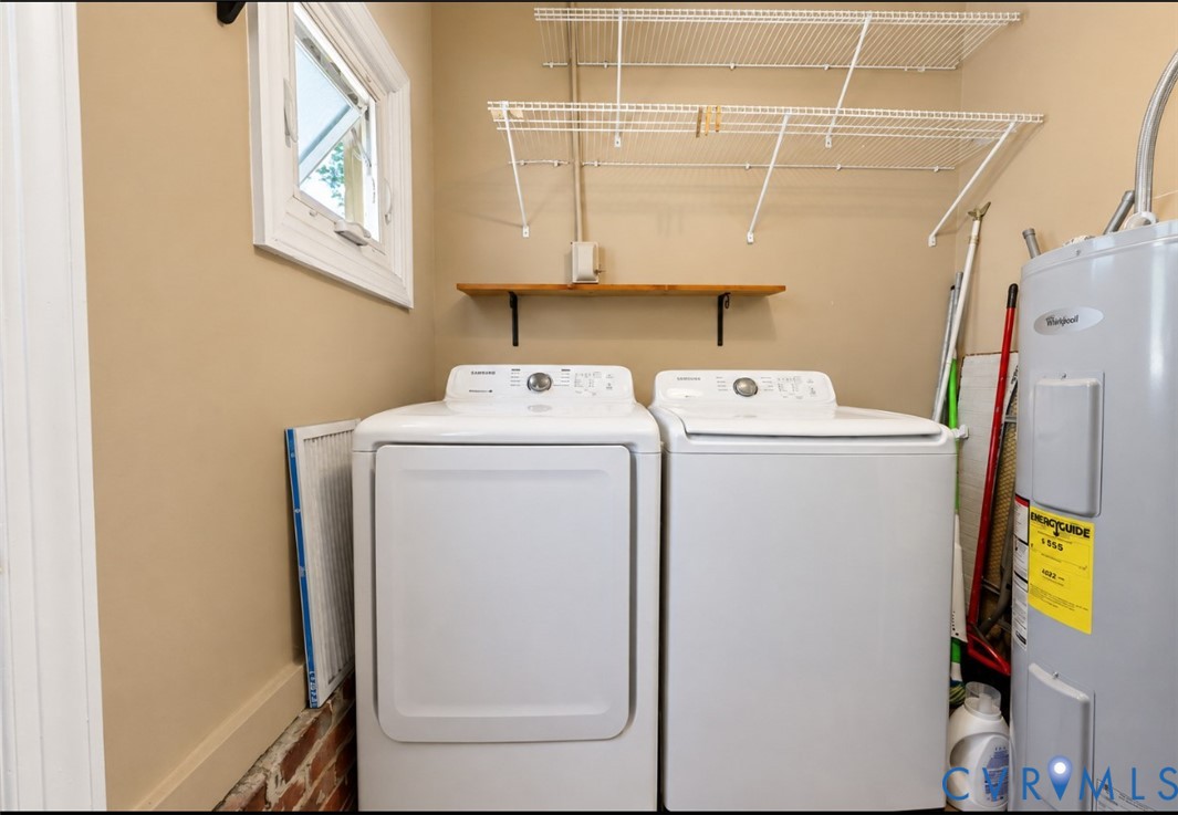 Full-size laundry appliances convey with overhead wire and wood shelving