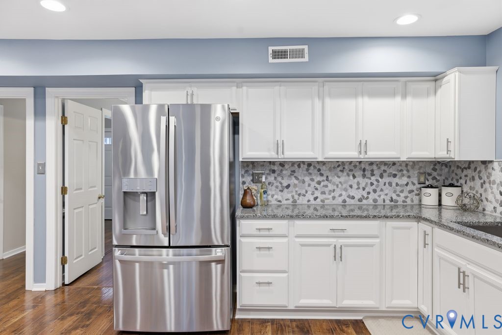 Stainless steel French door refrigerator complementing white shaker cabinetry