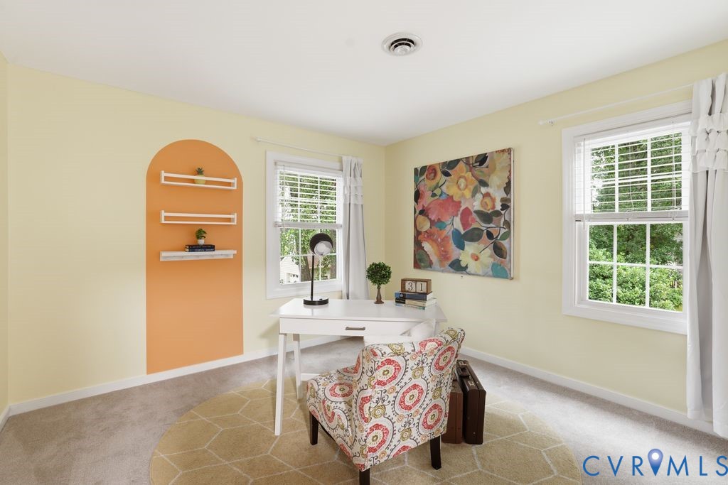 Carpeted room with light yellow walls and white trim