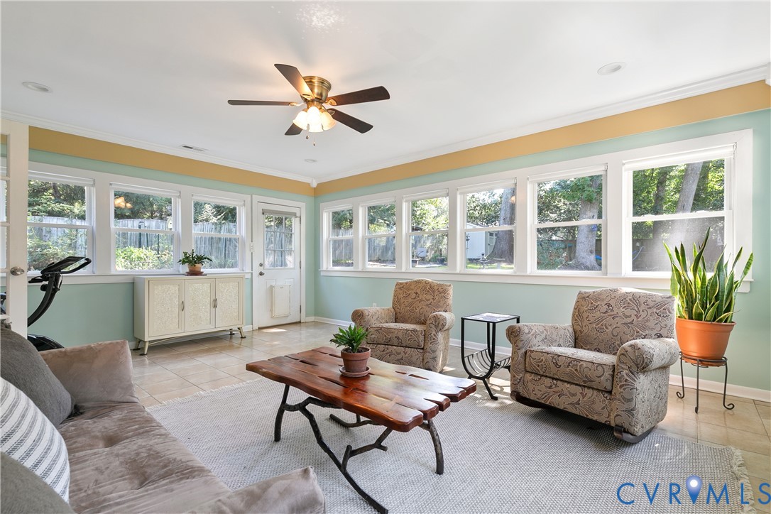 Tile flooring, recessed lighting, ceiling fan, multiple windows, and a glass-paneled door