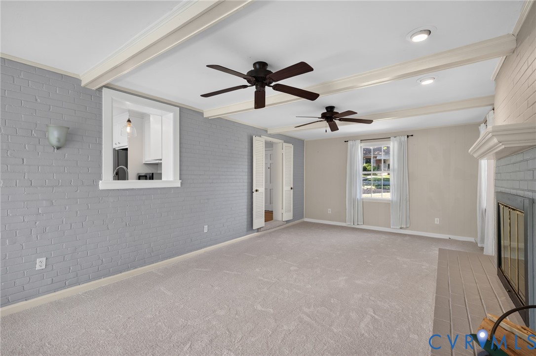 Exposed ceiling beams, recessed lighting, and dual ceiling fans