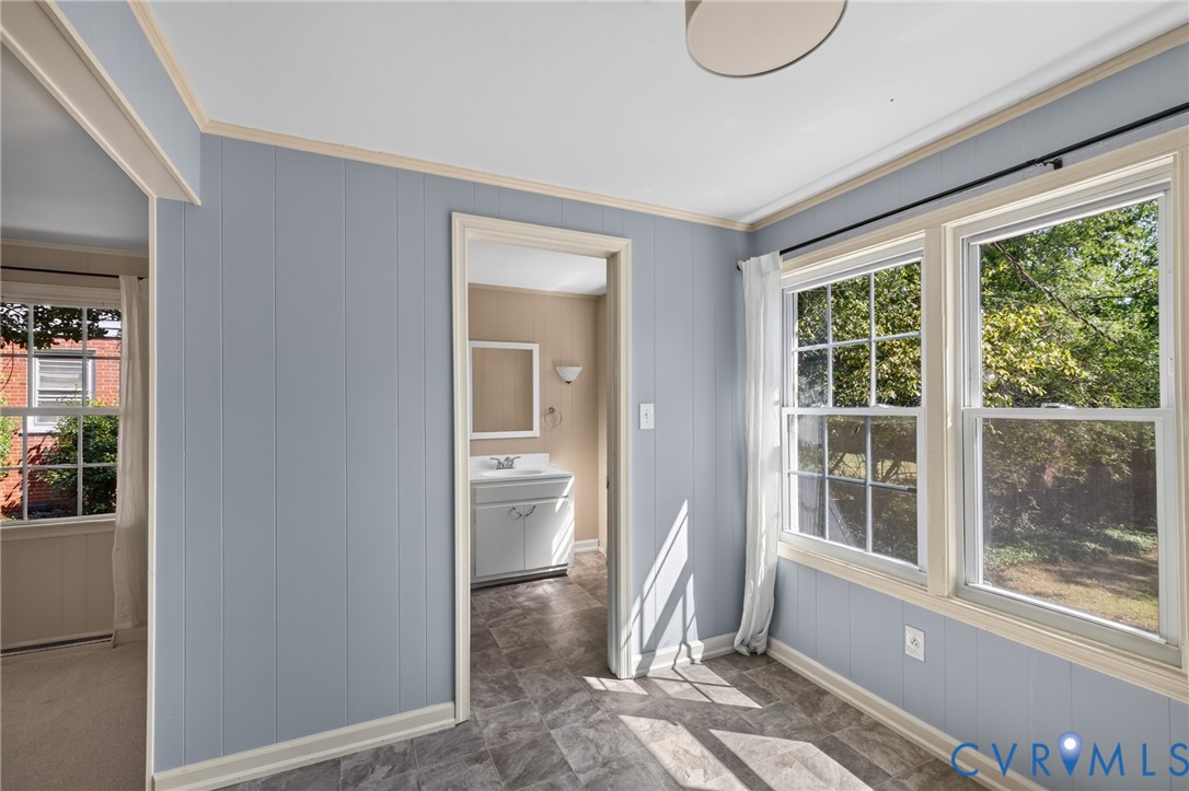 Light blue paneled walls, white trim, and a patterned flooring