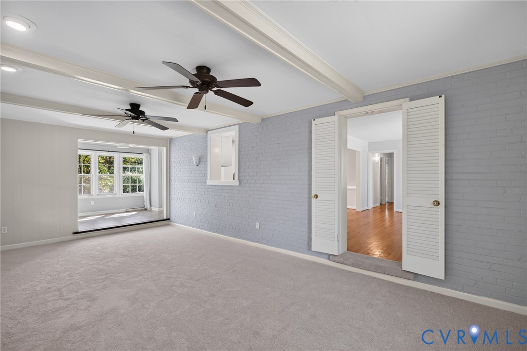 Exposed ceiling beams, recessed lighting, and twin ceiling fans