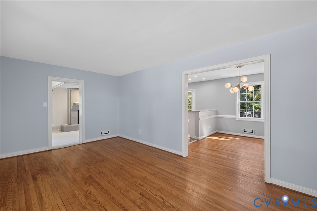Hardwood flooring, light blue wall paint, and white trim