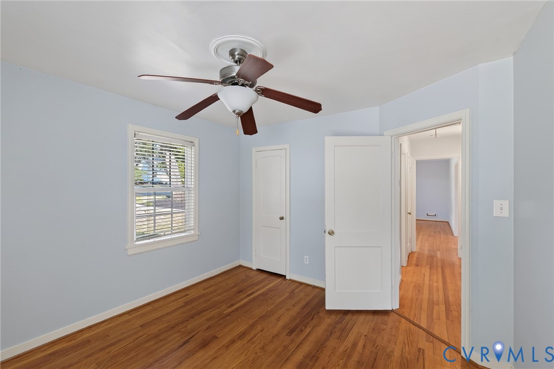 Hardwood flooring and a ceiling fan with integrated lighting
