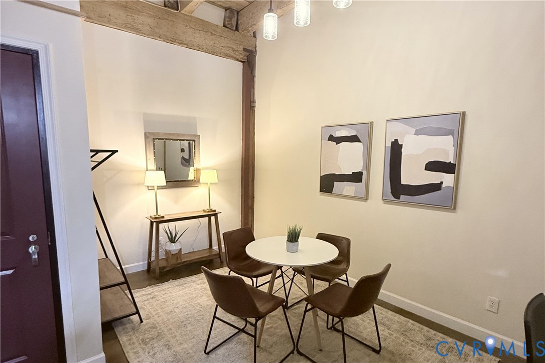 Dedicated dining area with exposed wood beams.