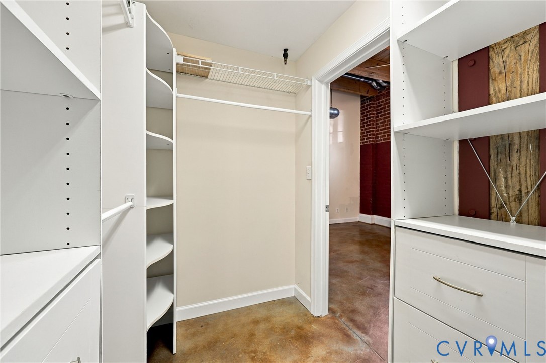Custom closet system featuring white shelving and integrated drawers