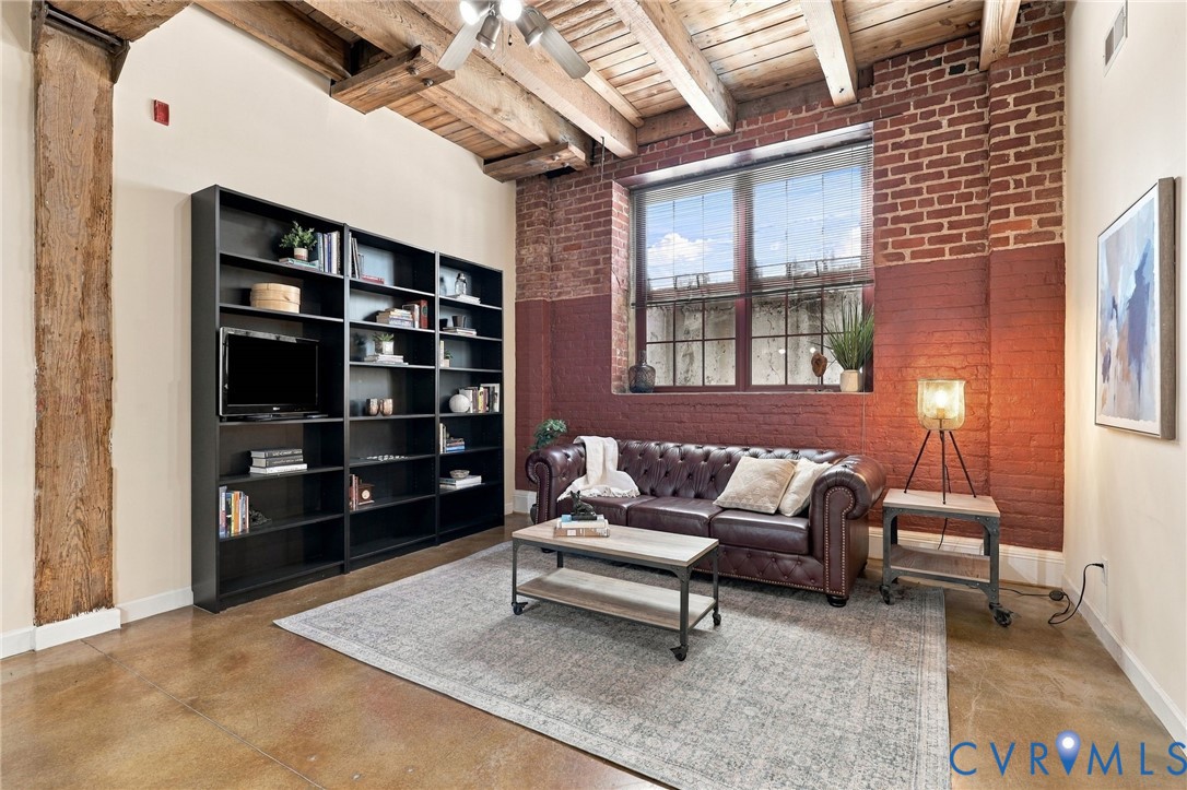 Exposed wood beam ceiling with new ceiling fan.