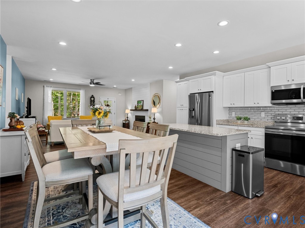 Open-concept living area featuring wood-finish flooring, recessed lighting, and a ceiling fan