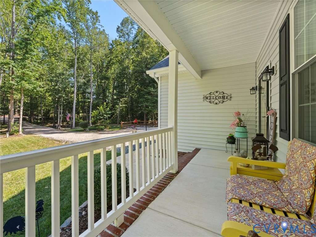 Expansive front porch featuring concrete flooring and white railing