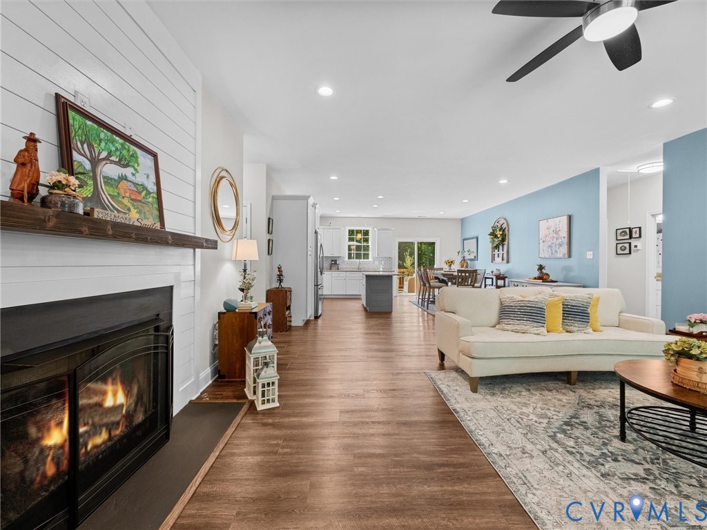 Fireplace with shiplap-style surround and wood mantel
